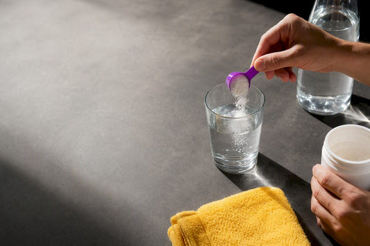 Hands measuring creatine into water