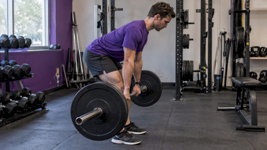 Runner performing a barbell Romanian deadlift